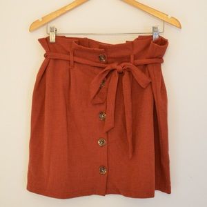 Chic burnt orange above-the-knee buttoned skirt